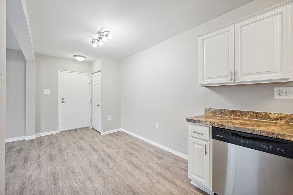 a kitchen and living room with white cabinets and a counter top at ReNew Odenton