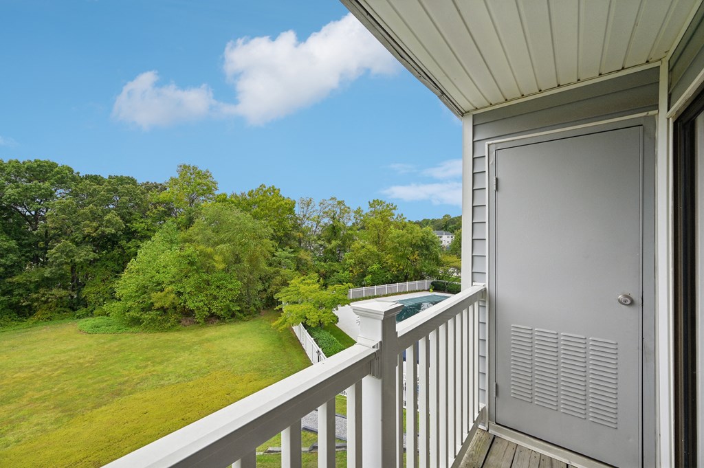 a view of the yard from the balcony of an apartment with a pool at ReNew Odenton