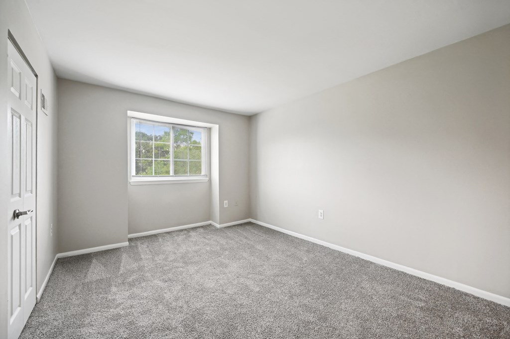 an empty room with carpet and a window at ReNew Odenton