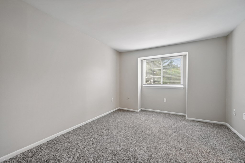 an empty room with carpet and a window at ReNew Odenton