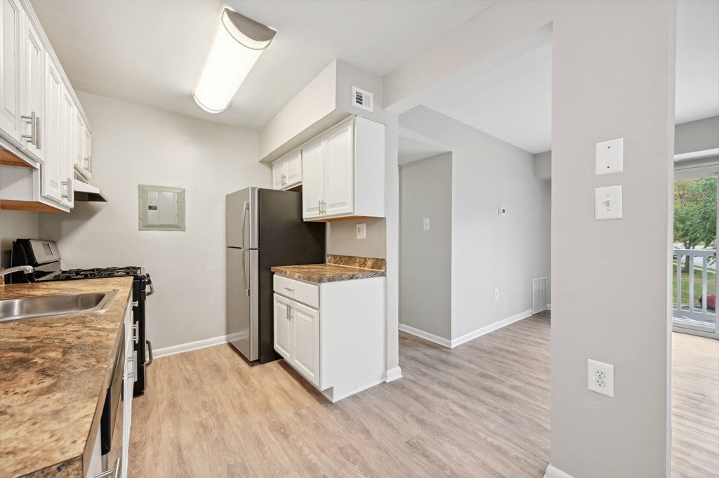 an open kitchen and living room with a stainless steel refrigerator at ReNew Odenton