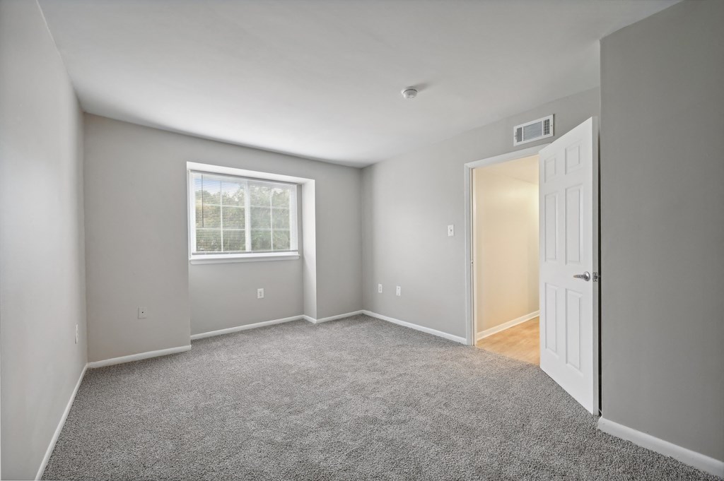 an empty room with a white door and a window at ReNew Odenton