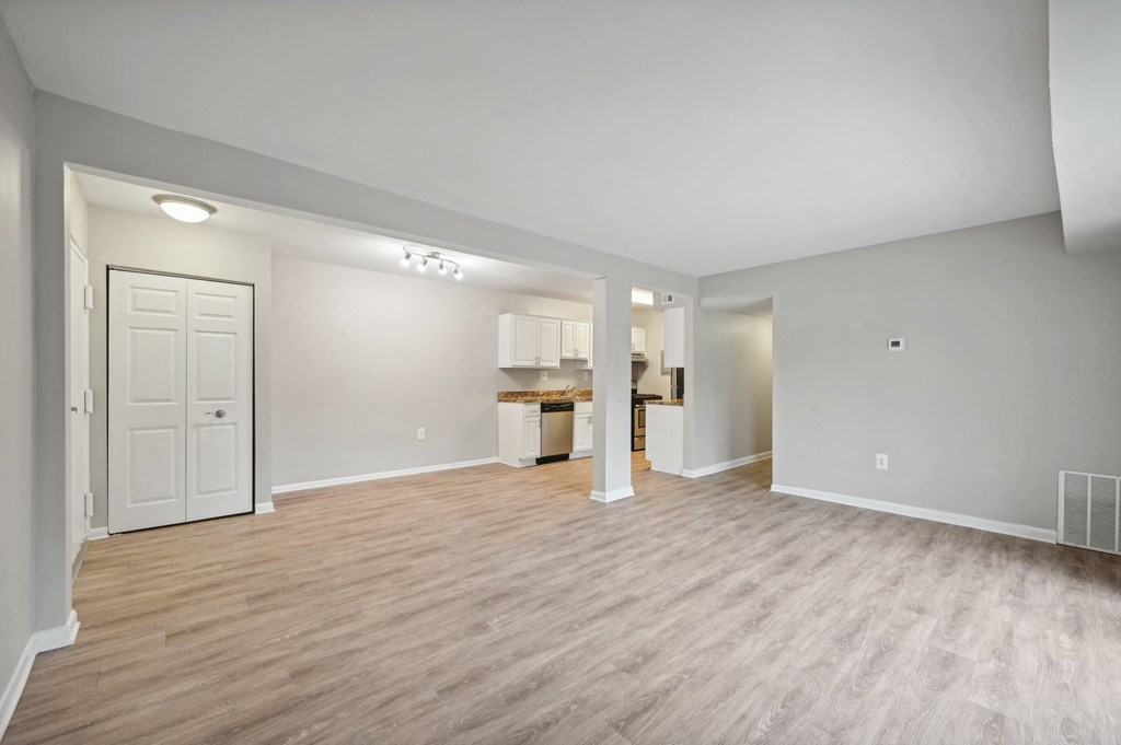 the living room and kitchen in a new home with wood flooring at ReNew Odenton