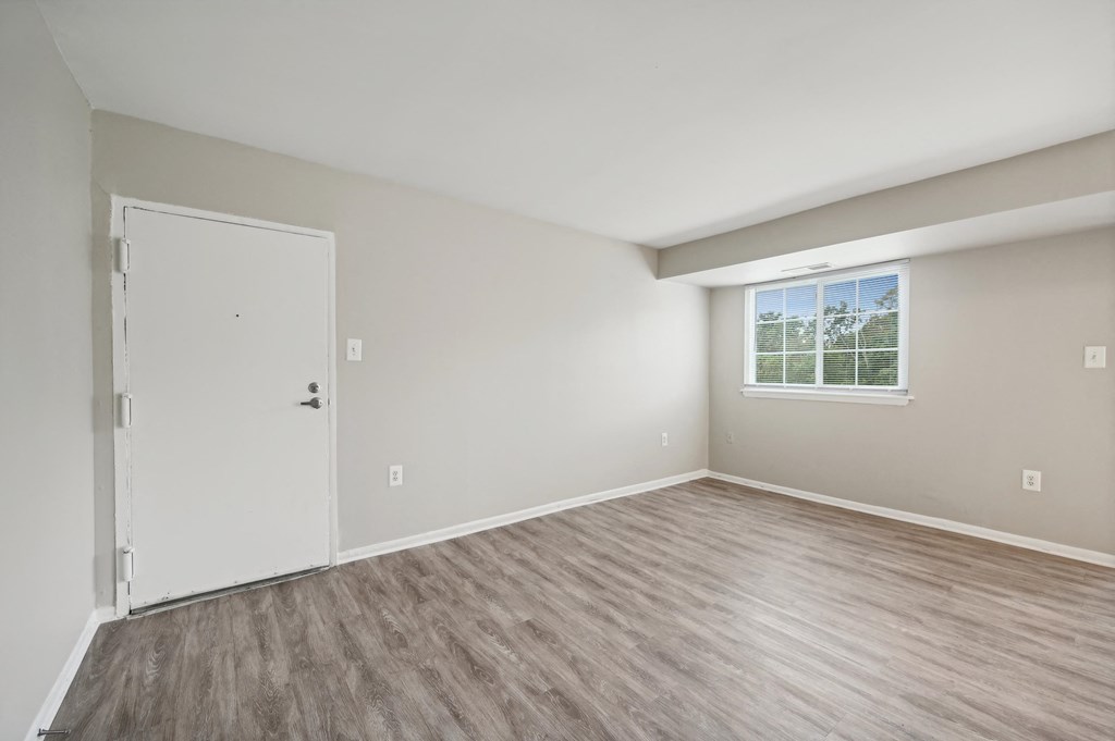 an empty bedroom with a door and a window at ReNew Odenton