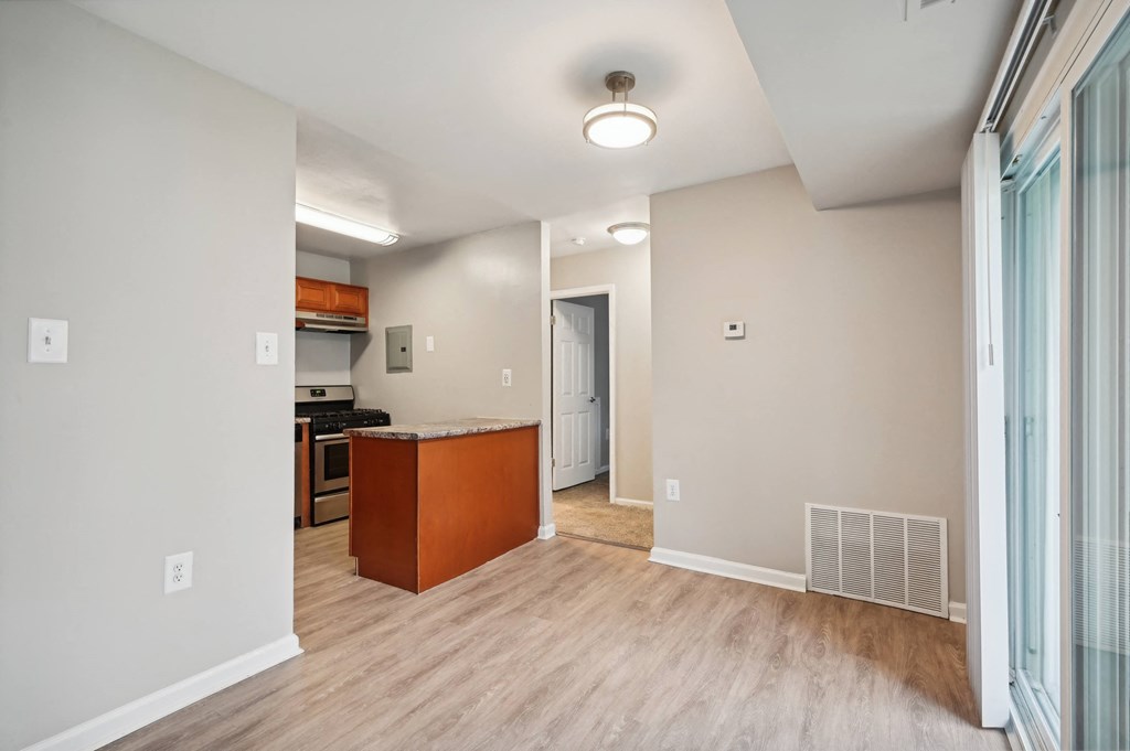 a renovated living room and kitchen with wood flooring and an open floor plan at ReNew Odenton