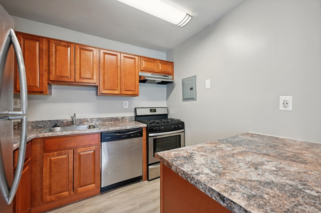 a kitchen with granite counter tops and stainless steel appliances at ReNew Odenton