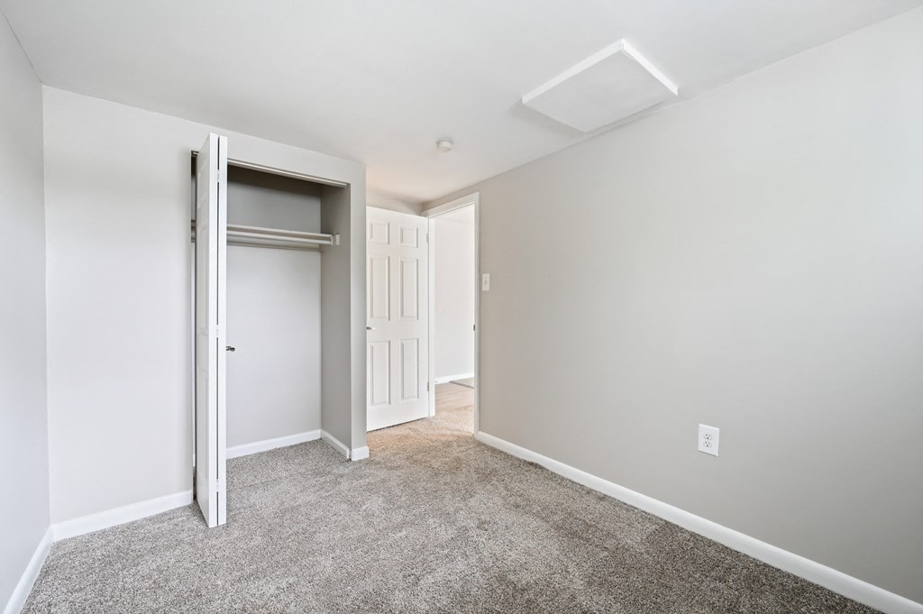 a bedroom with a closet and a door at ReNew Odenton