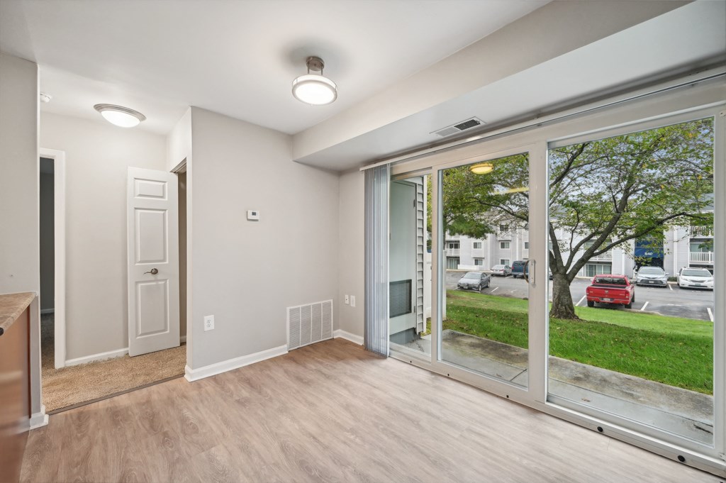 a living room with a large window and a door to the street at ReNew Odenton
