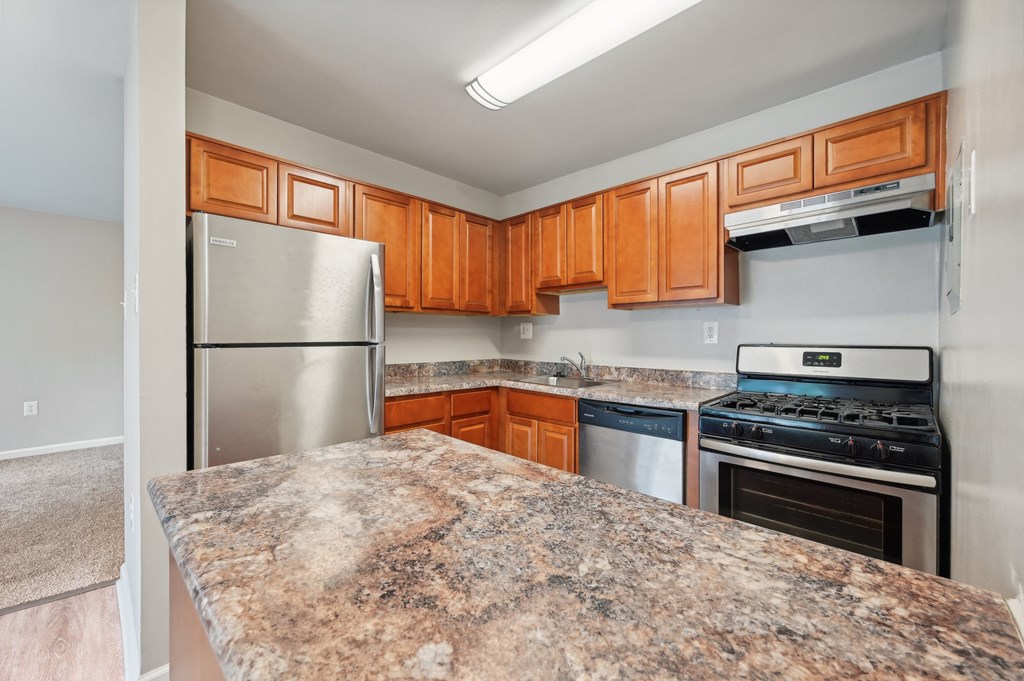 an updated kitchen with granite counter tops and stainless steel appliances at ReNew Odenton