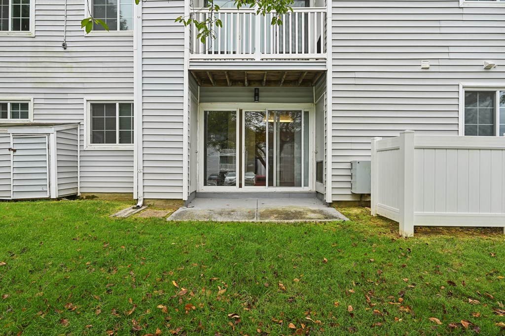 Exterior view into apartment building with patio and a balcony at ReNew Odenton