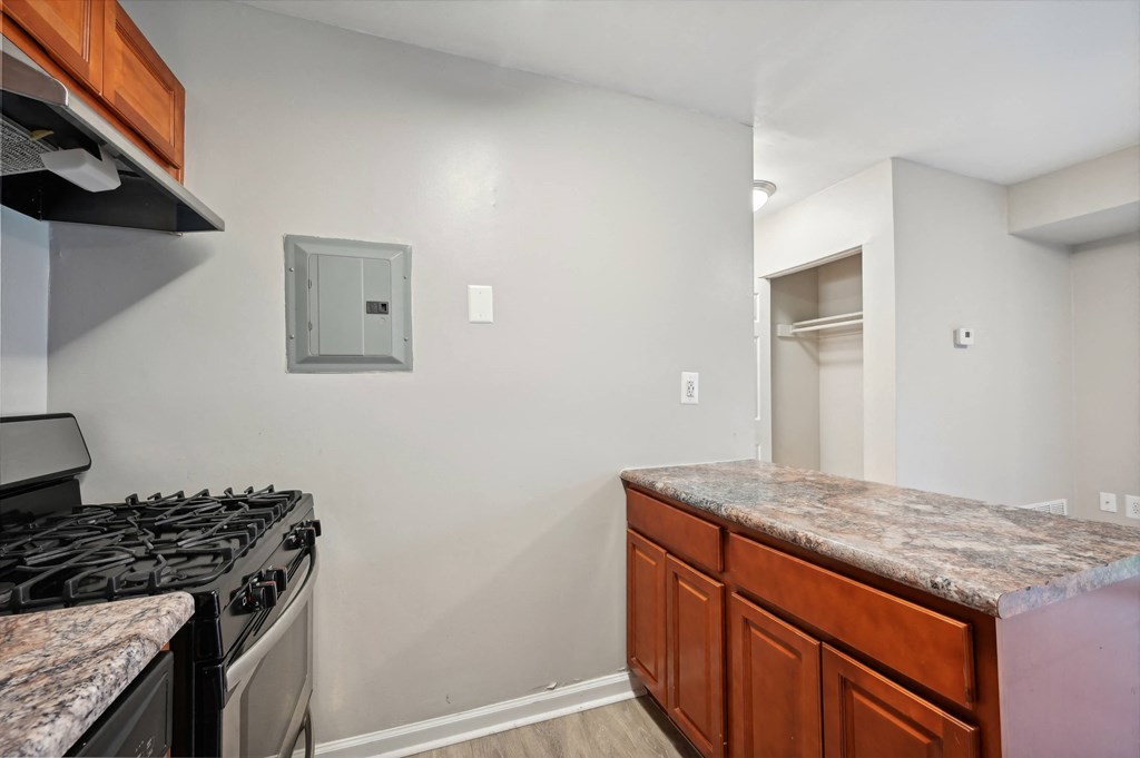 a kitchen with granite counter tops and a stove and a refrigerator at ReNew Odenton