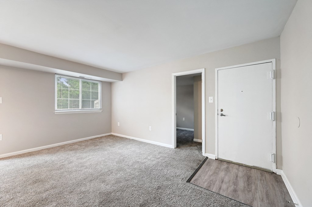 an empty room with carpet and a door at ReNew Odenton