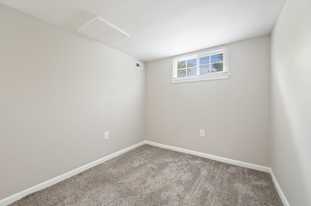 an empty room with carpet and a window at ReNew Odenton