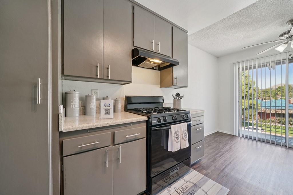 A modern kitchen with a black stove top oven.