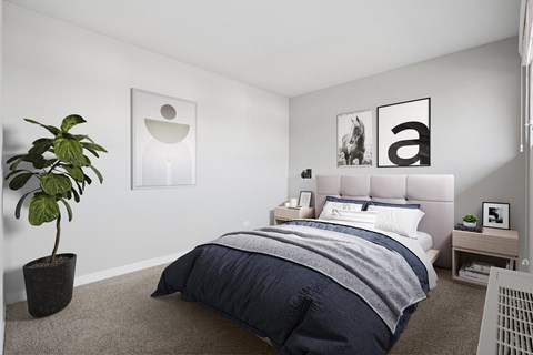 A bedroom with a bed, nightstand, and a plant.
