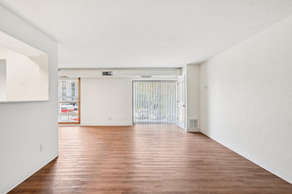 A room with wooden floors and white walls.
