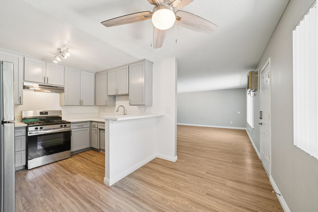 A kitchen with a view of the living room