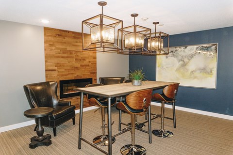 A modern dining room with a wooden table and chairs.