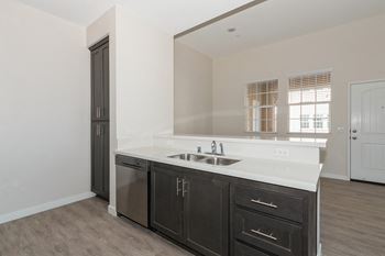 an empty kitchen with a large mirror and a sink