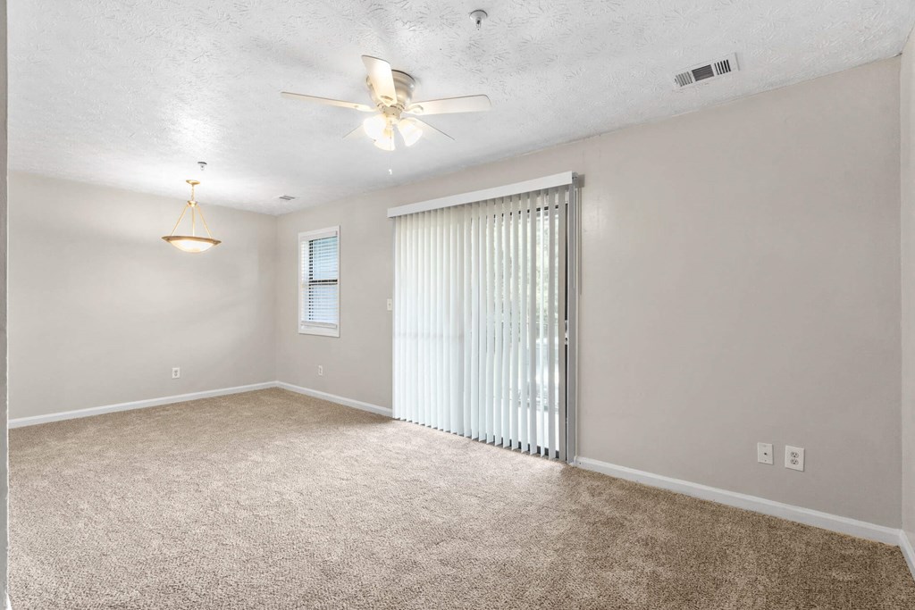 a bedroom with a ceiling fan and a sliding door to a closet at Alcovy Terrace, Covington, GA, 30014