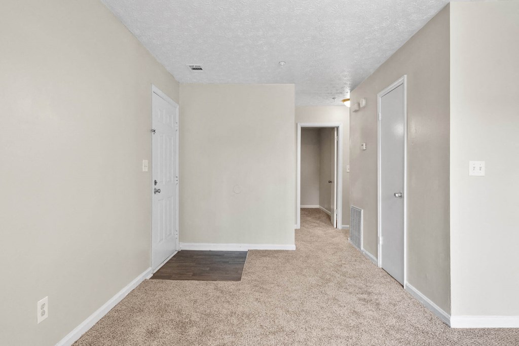 a bedroom with a carpeted floor and white walls at Alcovy Terrace, Georgia