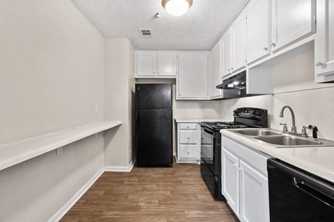 a kitchen with black appliances at Alcovy Terrace, Covington, GA