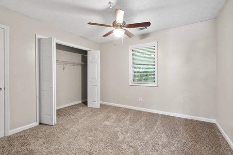 a bedroom with a ceiling fan and closet at Alcovy Terrace, Covington, 30014