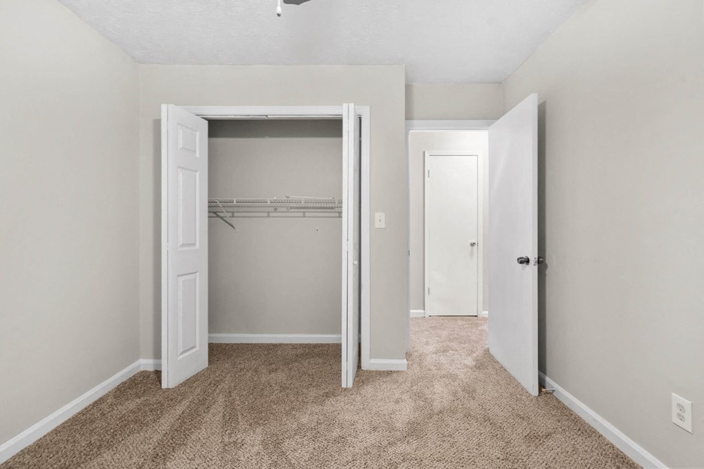 a bedroom with a closet and an open door at Alcovy Terrace, Covington, GA