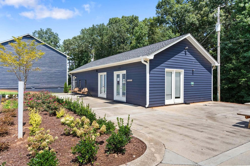 a small blue building with a driveway in front of it at Alcovy Terrace, Covington, 30014