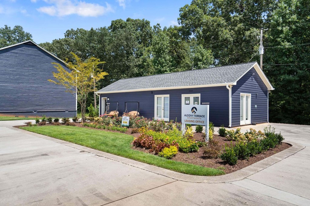 a blue house with a sign in front of it at Alcovy Terrace, Covington, GA