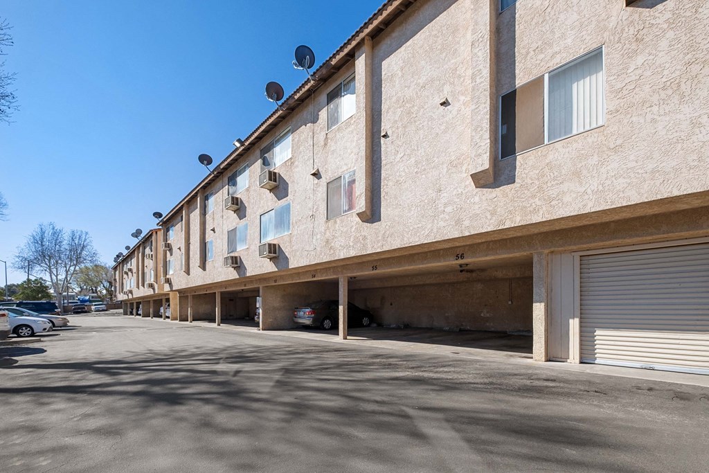 a large tan building with a parking lot in front of it at Alturas Paso Robles Apartment Homes, Paso Robles, 93446