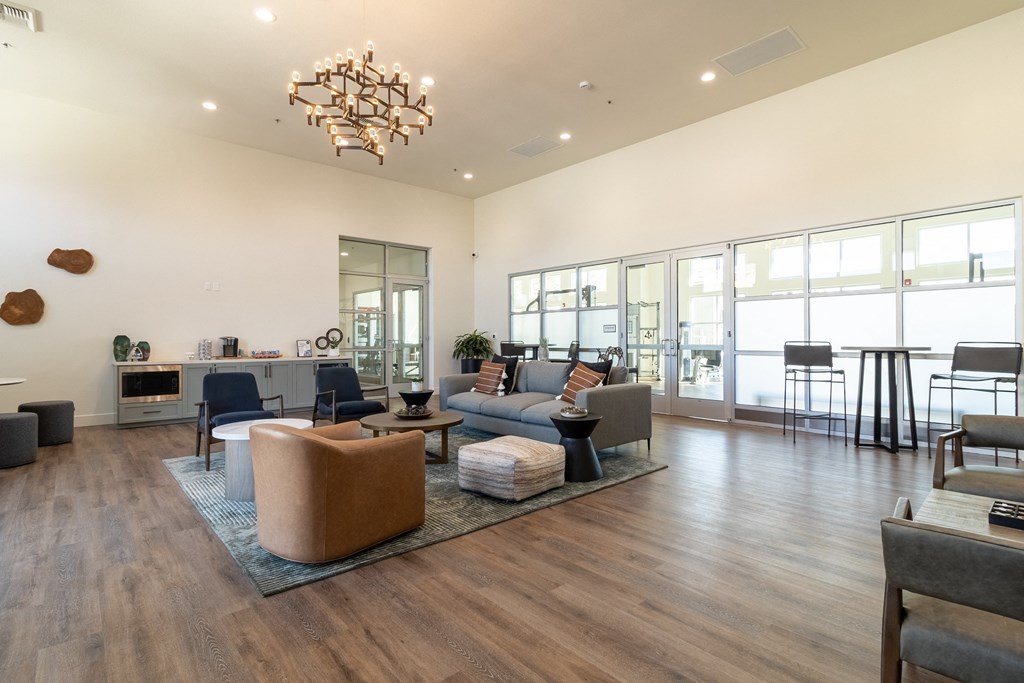 a living room with a couch and a table in front of windows at Arrive Paso Robles, Paso Robles, CA, 93446