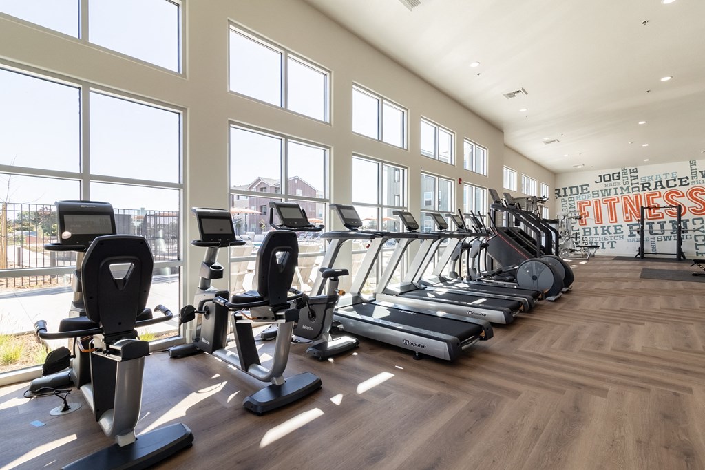 a gym with cardio machines and windows with a view of the city at Arrive Paso Robles, California, 93446