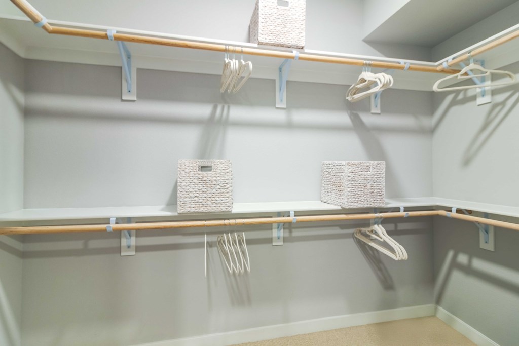 A walk-in closet with shelves and racks