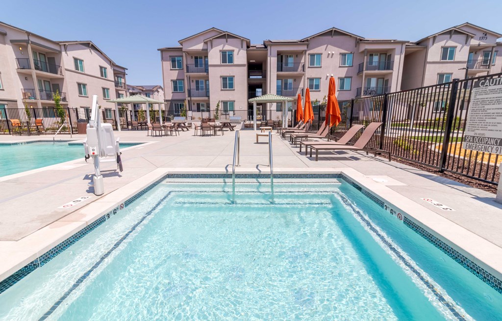 A swimming pool in front of apartment buildings.