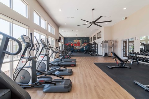 A gym with treadmills and elliptical machines.