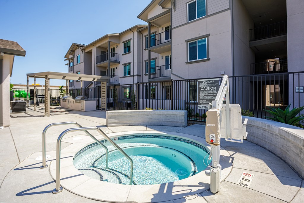 Hot tub with a bbq station in the background