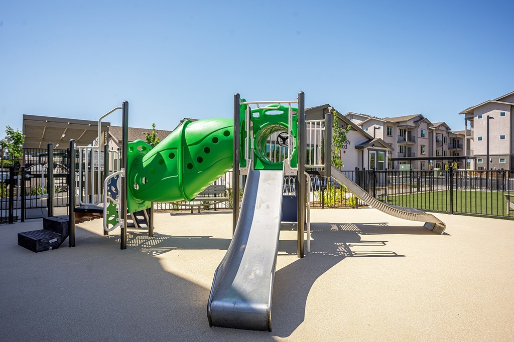 A playground with a green slide