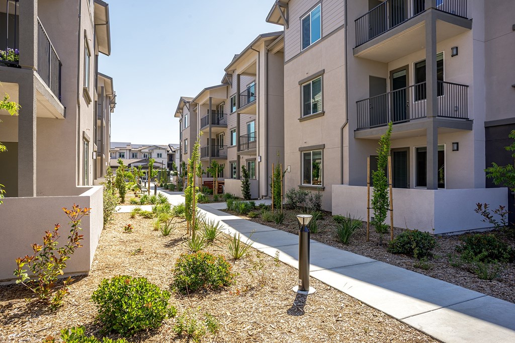 A row of modern apartment buildings with balconies.