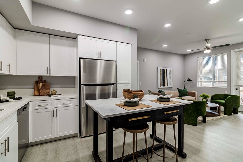 A modern kitchen with a table and chairs.