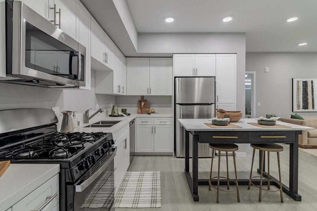 A modern kitchen with a black and white checkered floor.