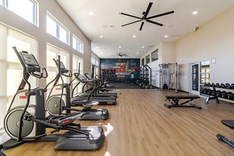 A gym with treadmills and elliptical machines.