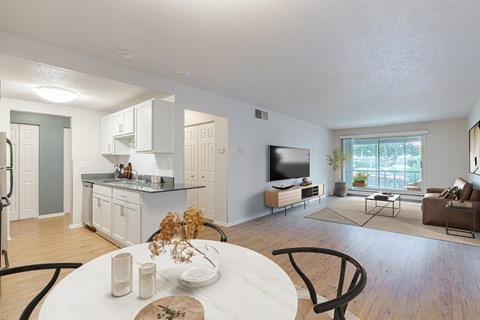 A modern kitchen with a dining table and chairs.