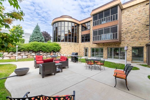 A patio area with a table and chairs outside a building.