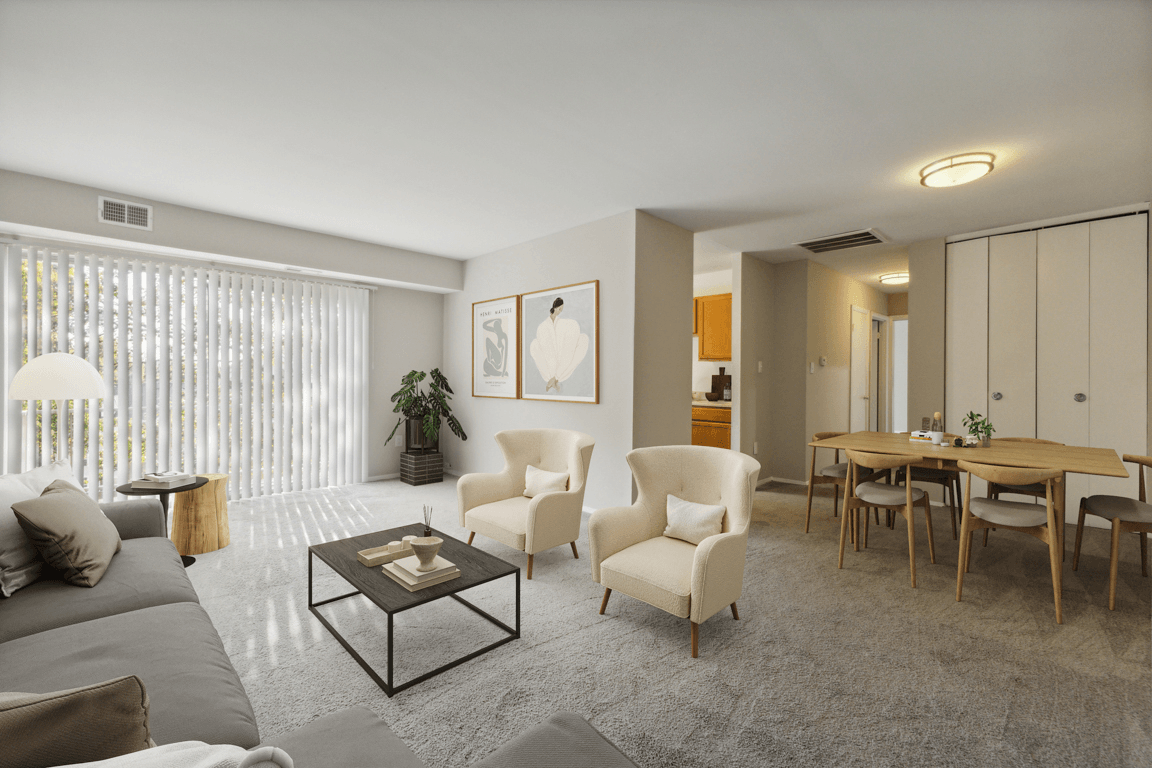 a living room with a couch and chairs and a dining room table