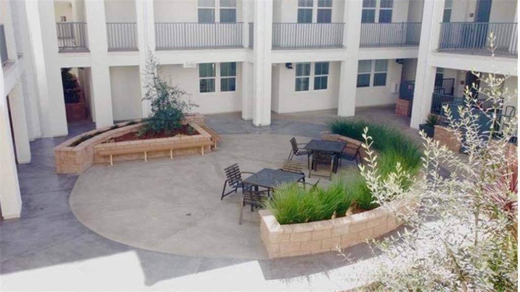 a patio with a table and chairs in front of a building at Arrive Los Carneros II, Goleta