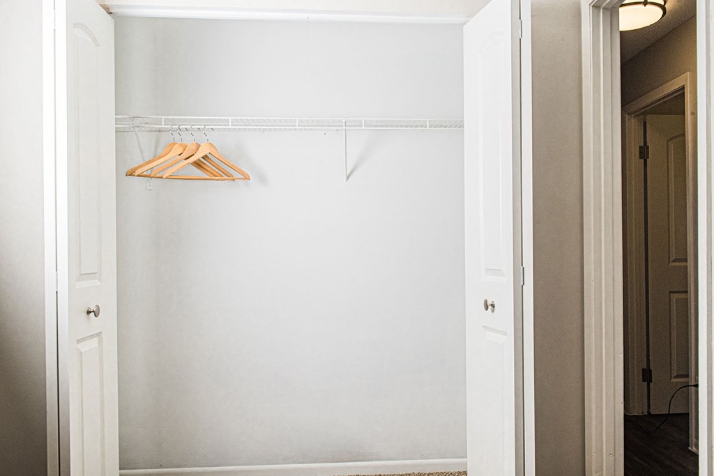 a white closet with a white hanger and a white door at Fifteen 98 Naperville, Illinois, 60563