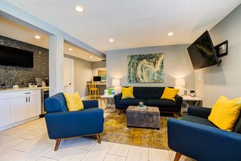 a living room with blue couches and a coffee table