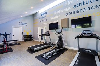 two treadmills and a tv in the gym at the preserve at polk
