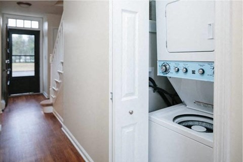 a white kitchen with a stove and a white door